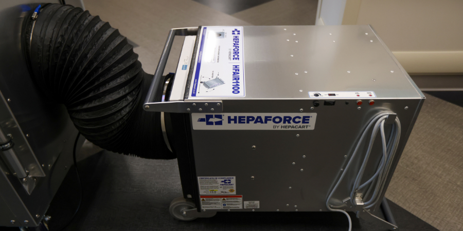 HEPAFORCE HFAIR4100 air scrubber with HEPA filtration and exhaust ducting set up in a healthcare facility hallway