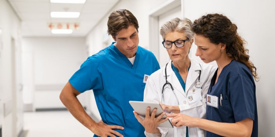 Doctor and nurses talking over a chart