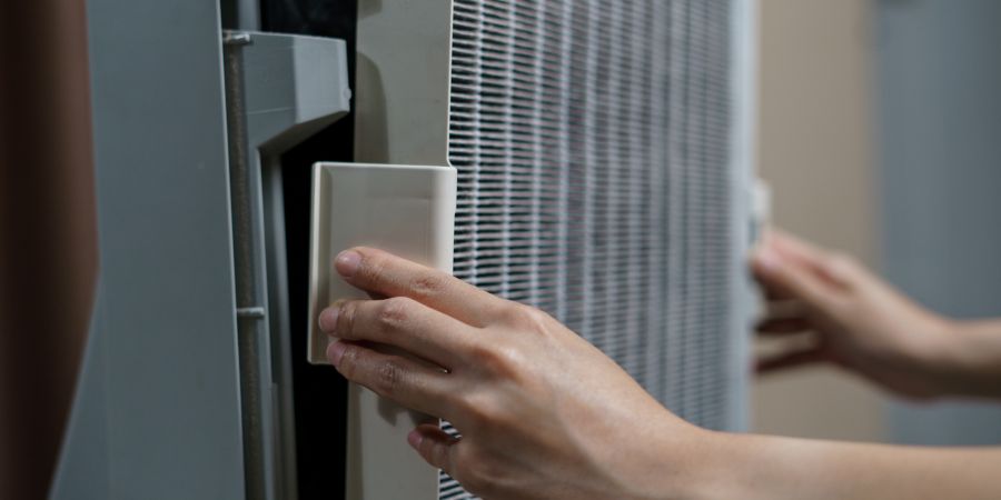 Person replacing an air filter