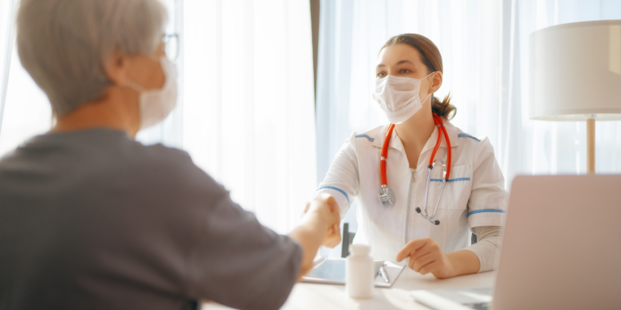 Hospital patient speaking with doctor. 